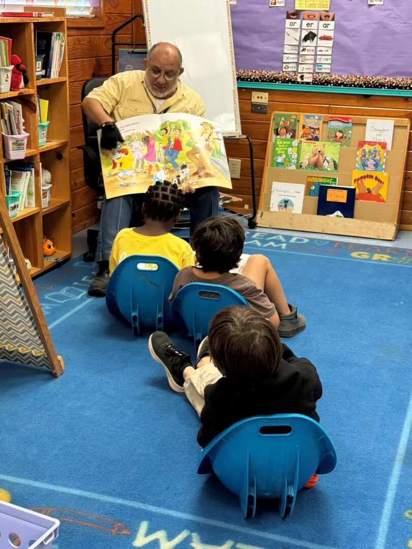 Man reading to children in a classroom.